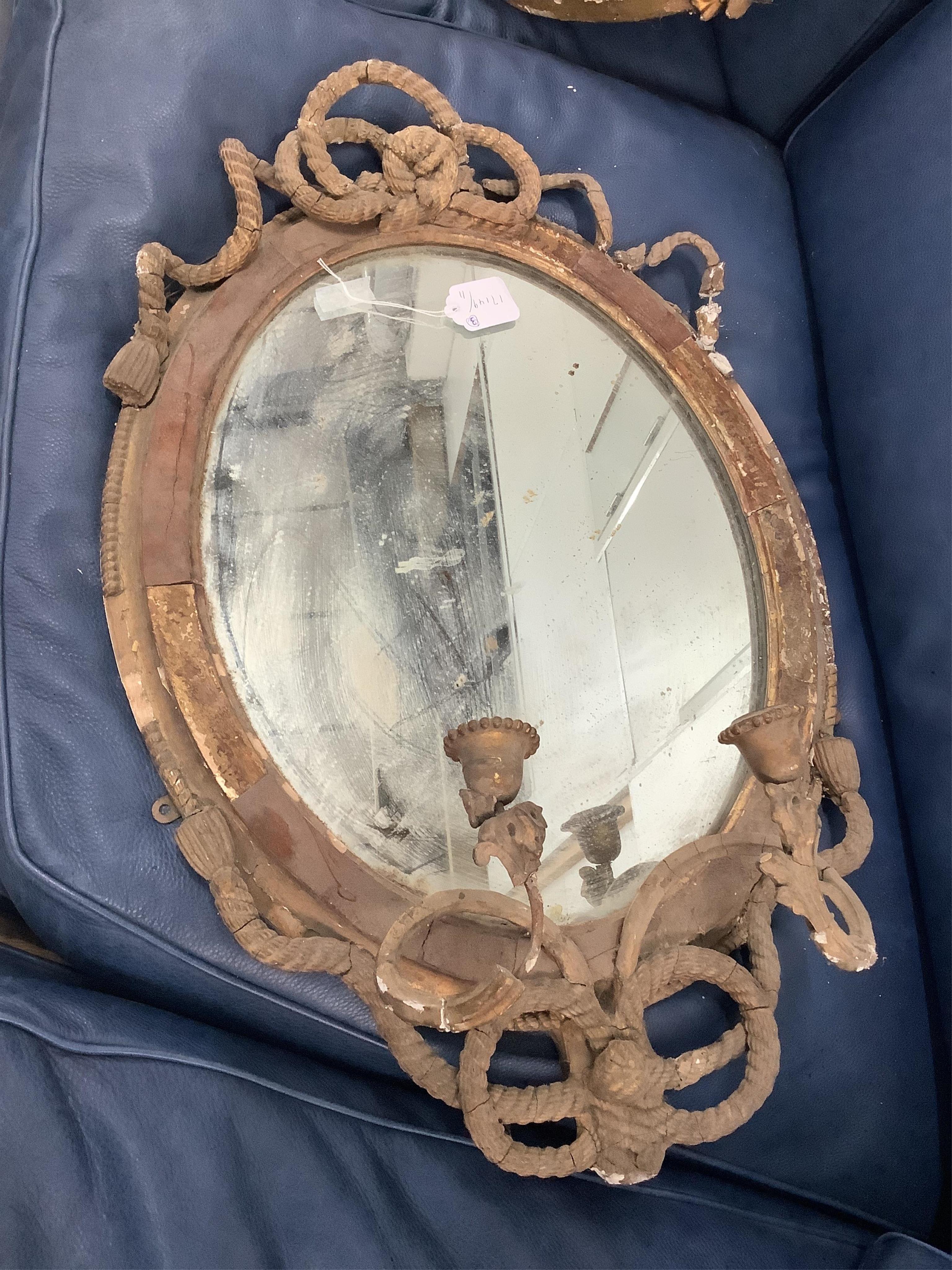 Two Regency circular convex wall mirrors, larger diameter 58cm together with two carved eagle surmounts. Condition - poor